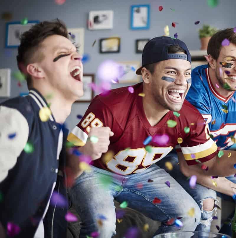 young men watching football